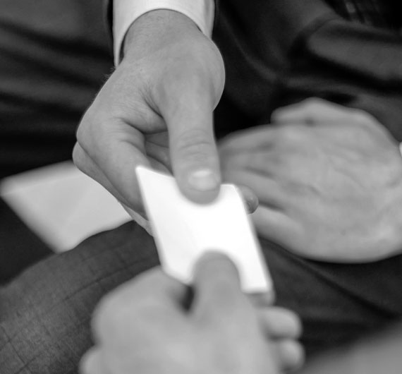 handing out business card male suit grayscale black and white