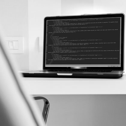 whaite room desk chair laptop code on screen grayscale black and white